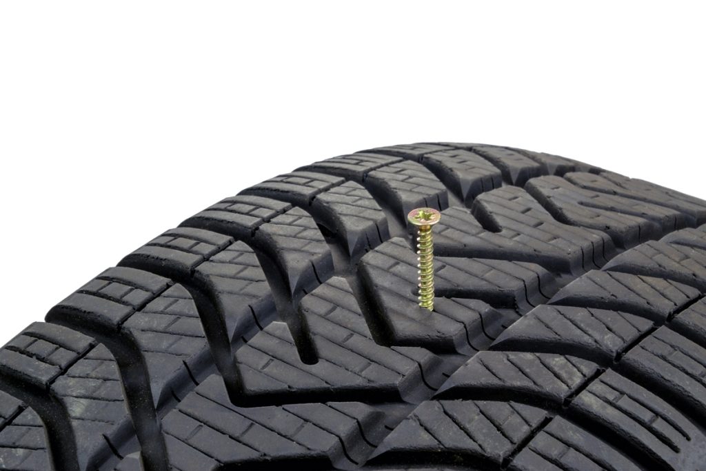 A Nail Puncture In The Middle Of The Tire'S Tread Area